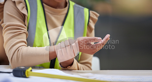 Image of Industry, closeup and female construction worker with wrist pain, injury or accident in her office. Medical emergency, engineering and zoom of a woman industrial employee with a sprain hand muscle.