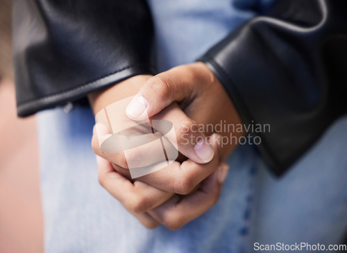 Image of Hands together, stress and woman closeup with anxiety from mental health and wellness problem outdoor. Prayer, hope and help of a person feeling nervous and sad with grief, fear and worried