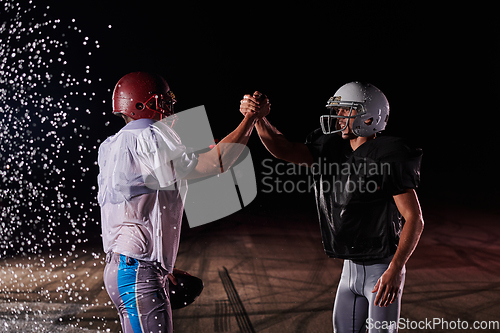 Image of Two american football players face to face in silhouette shadow on white background