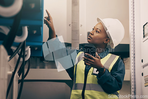 Image of Black woman, engineering technician and phone in control room to connect system, mechanic industry or machine maintenance. Female electrician, mobile technology or check power at electrical generator