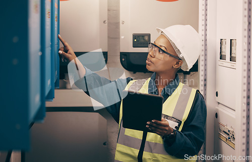 Image of Engineering, black woman or electrician on tablet for maintenance, server or machine board system. Female technician, digital technology or electrical mechanic in control room at industrial power box