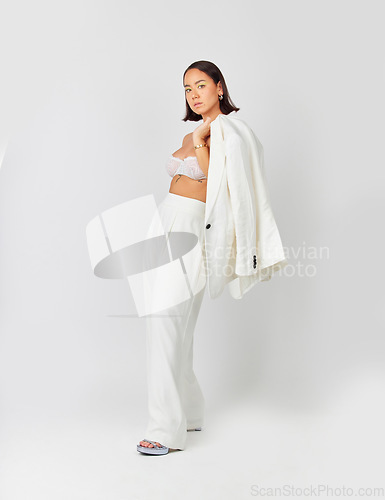 Image of Fashion, formal and portrait of a female model with a stylish, classy and fancy outfit in studio. Luxury, beautiful and full body of an Asian woman with elegant suit isolated by a white background.