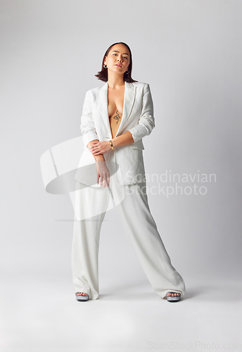 Image of Fashion, confidence and portrait of woman with suit for classy, sexy and fancy style in studio. Luxury, beautiful and full body of Asian female model with elegant outfit isolated by white background.