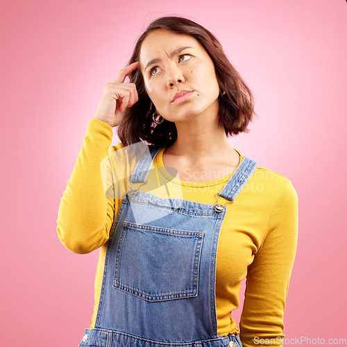 Image of Confused woman, thinking and scratch for ideas in studio, pink background and emoji for doubt, why and problem solving. Asian model daydream of decision, remember memory and brainstorming questions