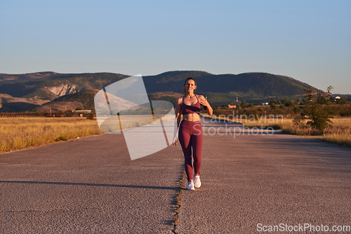 Image of Healthy young couple jogging in the city streets in the early morning with a beautiful sunrise in the background