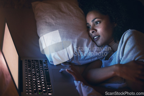Image of Laptop, bed and woman on internet at night for website, online social media and relax in home. Bedroom, computer and person streaming movie, film and video on pc technology with insomnia in house.