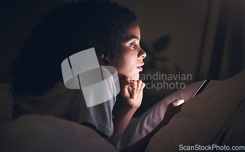 Image of Woman, cellphone and bed in night, reading or texting for chat, blog or social media post in apartment. Girl, smartphone and thinking in dark bedroom for online search, games or video on web in house