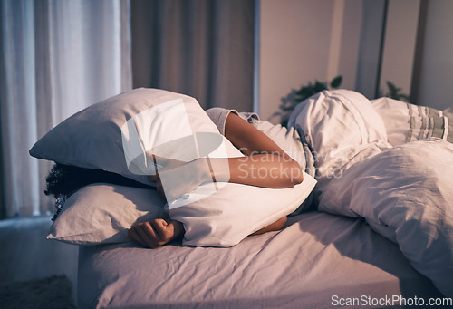 Image of Bed, insomnia and woman with pillow on face, tired and frustrated with stress, nightmare or dream. Fatigue, sleep problem and exhausted girl in bedroom with fear, scared at night and crisis in home.