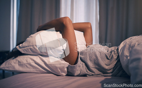 Image of Sleep, insomnia and woman with pillow on face, tired and frustrated with stress, nightmare or dream in bedroom. Fatigue, sleeping problem and girl in bed with fear, scared at night and crisis in home