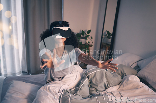 Image of Woman, bed and vr game in night, home and online in metaverse, matrix and stretching hands for challenge. Girl, augmented reality glasses and vision for 3d user experience, dark bedroom and apartment