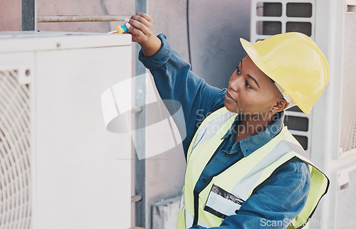 Image of Black woman, technician and building installation for solar panel, construction or vent on roof. African female person, contractor or engineer installing industrial equipment for architecture in city