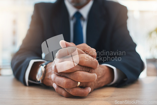 Image of Hands, authority and lawyer man waiting while sitting at a table in court during a case or trial closeup. Justice, law and legal with a male advocate in a courtroom for representation or legislation