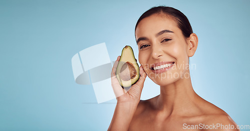 Image of Woman, avocado and portrait, natural beauty and skincare with eco friendly product isolated on blue background. Mockup space, happy female model and banner, fruit and sustainability in dermatology