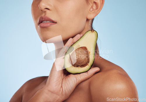 Image of Skincare, beauty and woman with avocado, natural makeup and facial detox on blue background. Health, wellness and closeup of model, organic luxury cleaning and cosmetics with fruit in hand in studio