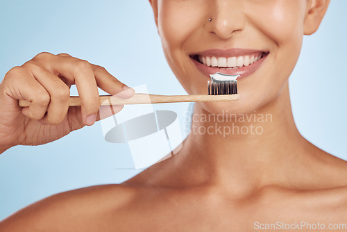 Image of Brushing teeth, toothbrush and woman with dental, hygiene and grooming with oral care isolated on blue background. Female model cleaning mouth, health and morning routine and toothpaste with smile