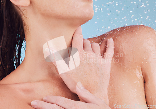 Image of Shower, woman and hands with cleaning for skincare with in studio for cleaning in blue background. Girl, hygiene and closeup with water for washing or beauty routine with self care for wellness.