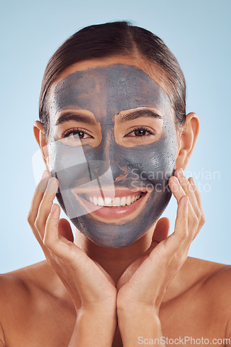 Image of Woman, face mask and charcoal for beauty, skincare and natural cosmetics cleaning product on studio, blue background. Portrait of person or model in facial collagen and mud skin care for dermatology