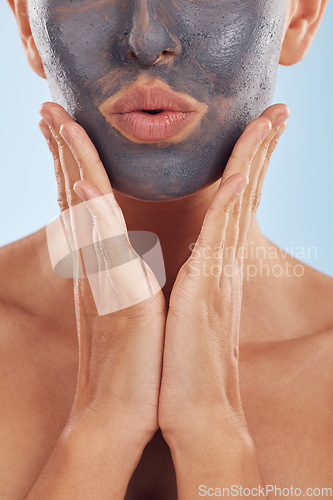 Image of Face mask, charcoal and beauty of woman with skincare facial treatment isolated in a blue studio background. Skin, cosmetic and young female person with clean, hydration and dermatology cream