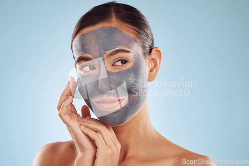 Image of Clay face mask, skincare and woman with beauty in studio isolated on blue background. Cosmetics, model and natural facial treatment for peeling to exfoliate skin, dermatology or cleaning for wellness