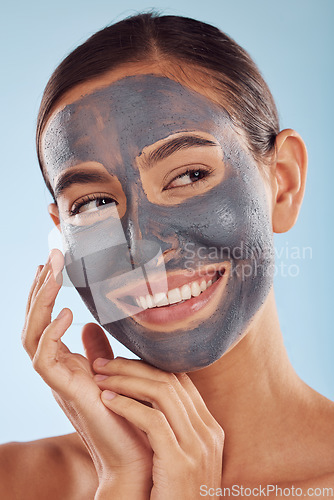 Image of Woman thinking, face mask and charcoal for skincare, natural beauty and cosmetics benefits on studio, blue background. Ideas of happy person or model with facial collagen, skin care and dermatology