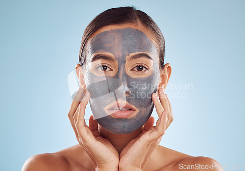 Image of Face mask, skincare and woman with beauty, dermatology and girl on a blue studio background. Portrait, female person and model with cosmetics, glow and aesthetic with hygiene, hydration and charcoal