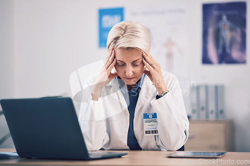 Image of Headache, doctor and pain of woman at laptop in medical office in burnout, mental health problem and stress. Frustrated, tired and mature healthcare worker in fatigue, migraine and anxiety of mistake