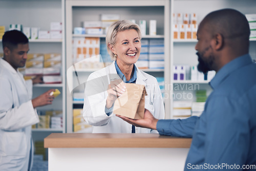 Image of Happy woman, pharmacist and paper bag for patient, healthcare or medication at the pharmacy. Female person or medical professional giving pills, drugs or pharmaceuticals product to customer at clinic