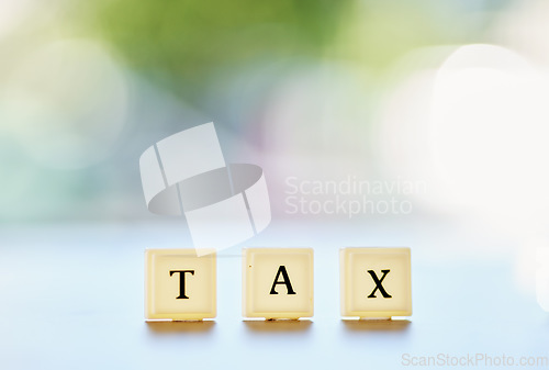 Image of Tax, word or message on wood blocks or letters writing on financial, report or management of money on a bokeh background space. Accounting mockup, planning for finance or taxes on audit in the future
