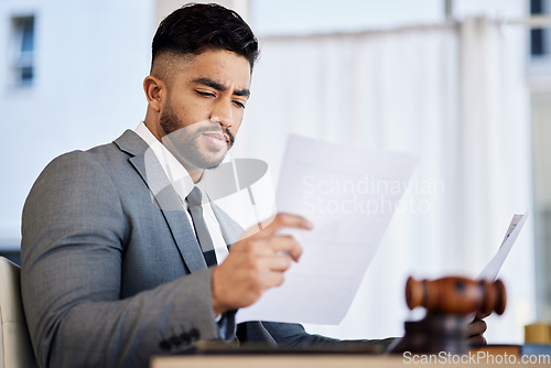 Image of Work, reading and a lawyer with a document in an office for business, justice and a legal contract. Serious, desk and a corporate advocate with paperwork or a report on a case or review of a proposal