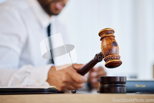 Image of Hand, gavel and a man judge in court for order at a verdict in a criminal case or trial closeup. Justice, law or legal with a magistrate hammer in a courtroom for a hearing of evidence or legislation
