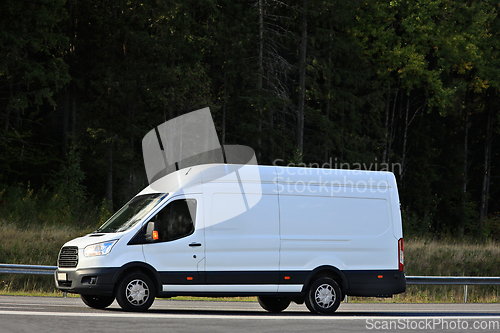 Image of White Delivery Van at Speed on Highway