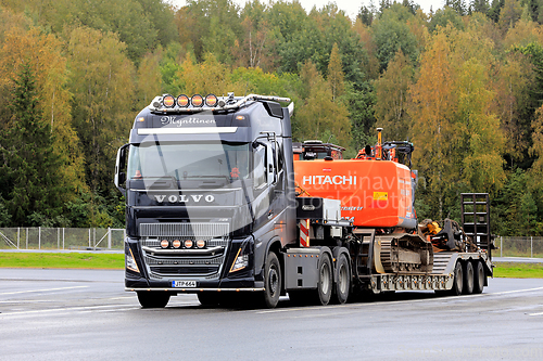 Image of Black Volvo FH16 Truck Hauls Excavator