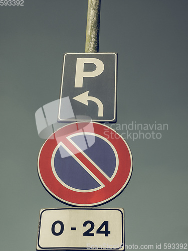 Image of Vintage looking No parking sign over blue sky