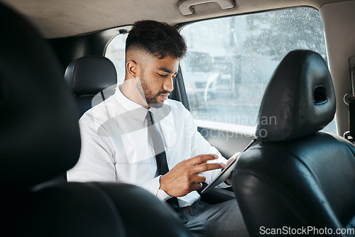 Image of Business man, tablet and drive in car for online search, trading or reading stock market news in traffic. Indian trader, focus and scroll on digital tech app, financial website or travel in transport