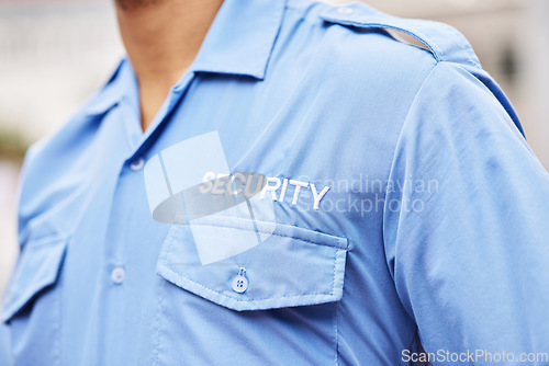 Image of Closeup of security guard, police officer and blue shirt for crime watch, surveillance and legal safety. Person, uniform and service of cop, law enforcement worker and bodyguard on patrol for justice