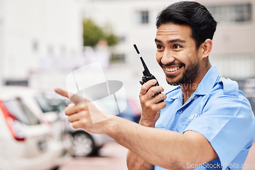 Image of Happy, pointing and security with a walkie talkie in the city for communication on parking lot safety. Smile, thinking and an Asian worker with gear for talking and a warning in town for work