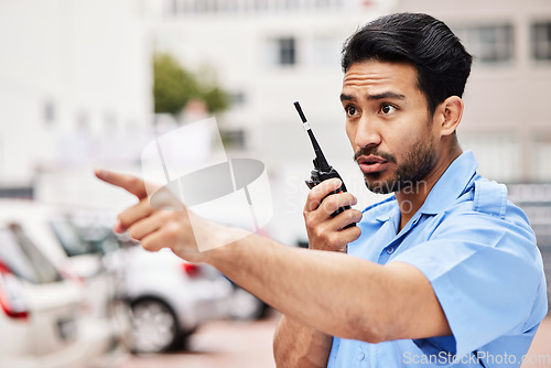 Image of Security man, radio and point in street for inspection, law or warning with call, backup and city. Police officer, outdoor and communication to stop crime on walkie talkie, public services or safety