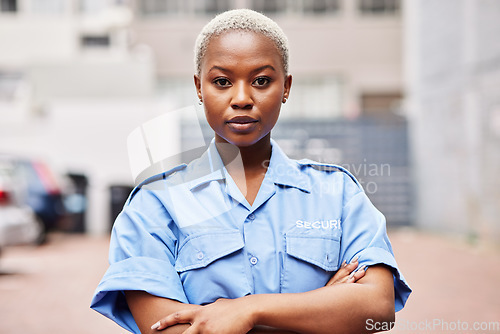 Image of Portrait, black woman and security guard with arms crossed for surveillance service, safety and urban watch. Law enforcement, bodyguard or serious female police officer in blue shirt for city patrol