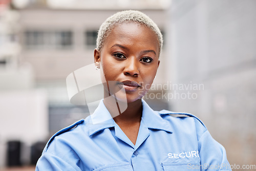 Image of Portrait, woman and security guard in city for surveillance service, safety and patrol. Law enforcement, bodyguard or face of black female police officer in blue shirt for crime watch in urban street