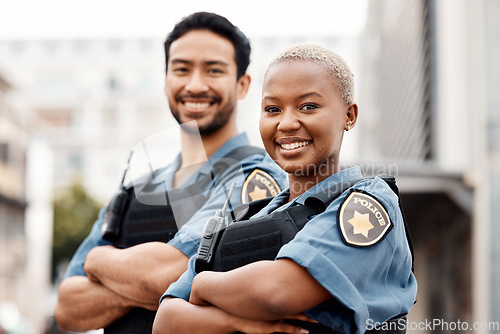 Image of Happy police, team and arms crossed in confidence for city protection, law enforcement or crime. Portrait of man and woman officer standing ready for justice, security or teamwork in an urban town