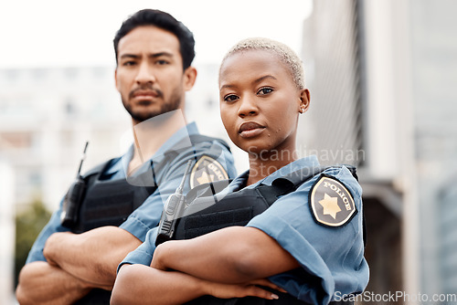 Image of Police, team and arms crossed in confidence for city protection, law enforcement or crime. Portrait of confident man and woman officer standing ready for justice, security or teamwork in urban town