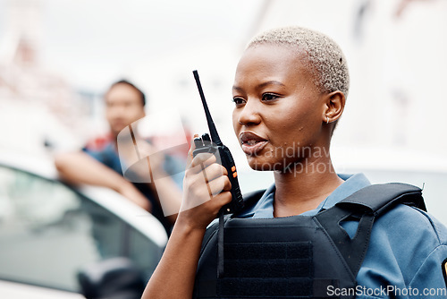 Image of Black woman, police and walkie talkie for radio in city communication, reinforcement or emergency. African female person, security guard or cop calling backup for crime on patrol in urban town street