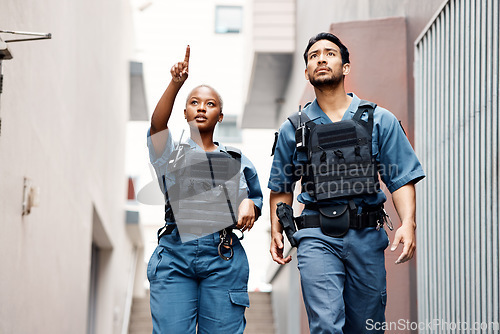 Image of Teamwork, crime and police in the city for justice, protection and law enforcement mission. Serious, collaboration and young woman and man security officers working with guns together in urban town.