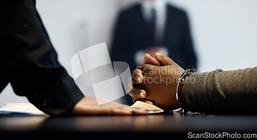 Image of Interrogation, legal and crime with hands of people in prison for law, security and questions. Justice, handcuffs and police with closeup of criminal and detective for information, jail and arrest