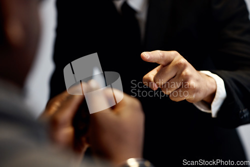 Image of Criminal, hands pointing at man and interrogation with police officer, detective or lawyer with handcuffs. Anger, law questions and prisoner at arrest, men in legal interview for crime investigation.