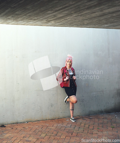 Image of Education, thinking and student with a woman punk leaning against a gray wall on the campus of her university. Gen z, idea and scholarship with a young female pupil standing at college for learning