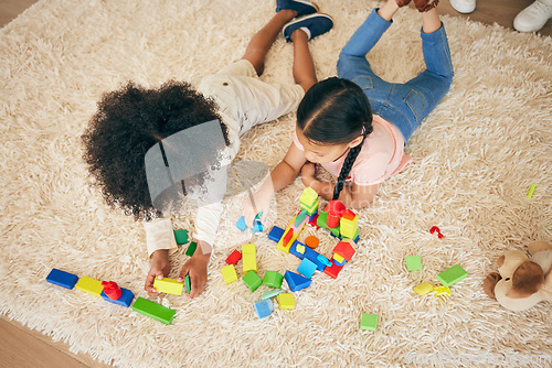 Image of Relax, play and above of children on floor with building blocks for learning, education and child development. Family, home and top view of girls in living room with toys for fun, creativity or games