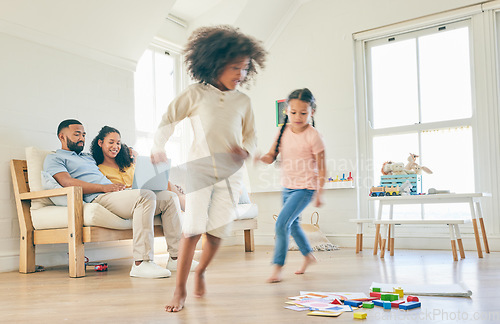 Image of Family, toys and children running in a home with parents streaming on a laptop in lounge together for creative fun. Living room, happy and development of kids playing with games by mom and dad