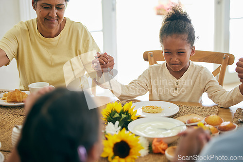 Image of Praying, parents and child holding hands for lunch, dinner or breakfast together with grandparents at home. Family, religion and mother, dad and girl giving thanks, gratitude and prayer for food