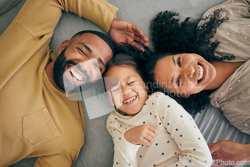 Image of Happy family, above and kid smile or happy with parents together in the morning laughing in a bedroom on a bed. Relax, mom and dad enjoy quality time with kid with happiness, bonding and love